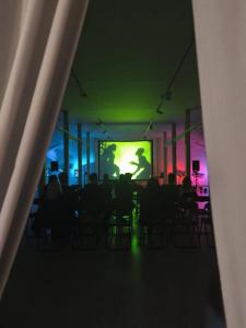 Zarys sali. W głębi prezentacja na ekranie.